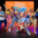 Blippi with Meekah on stage holding an electronic guitar. People are dancing, singing and moving like Blippi. “Be Like Blippi Tour”